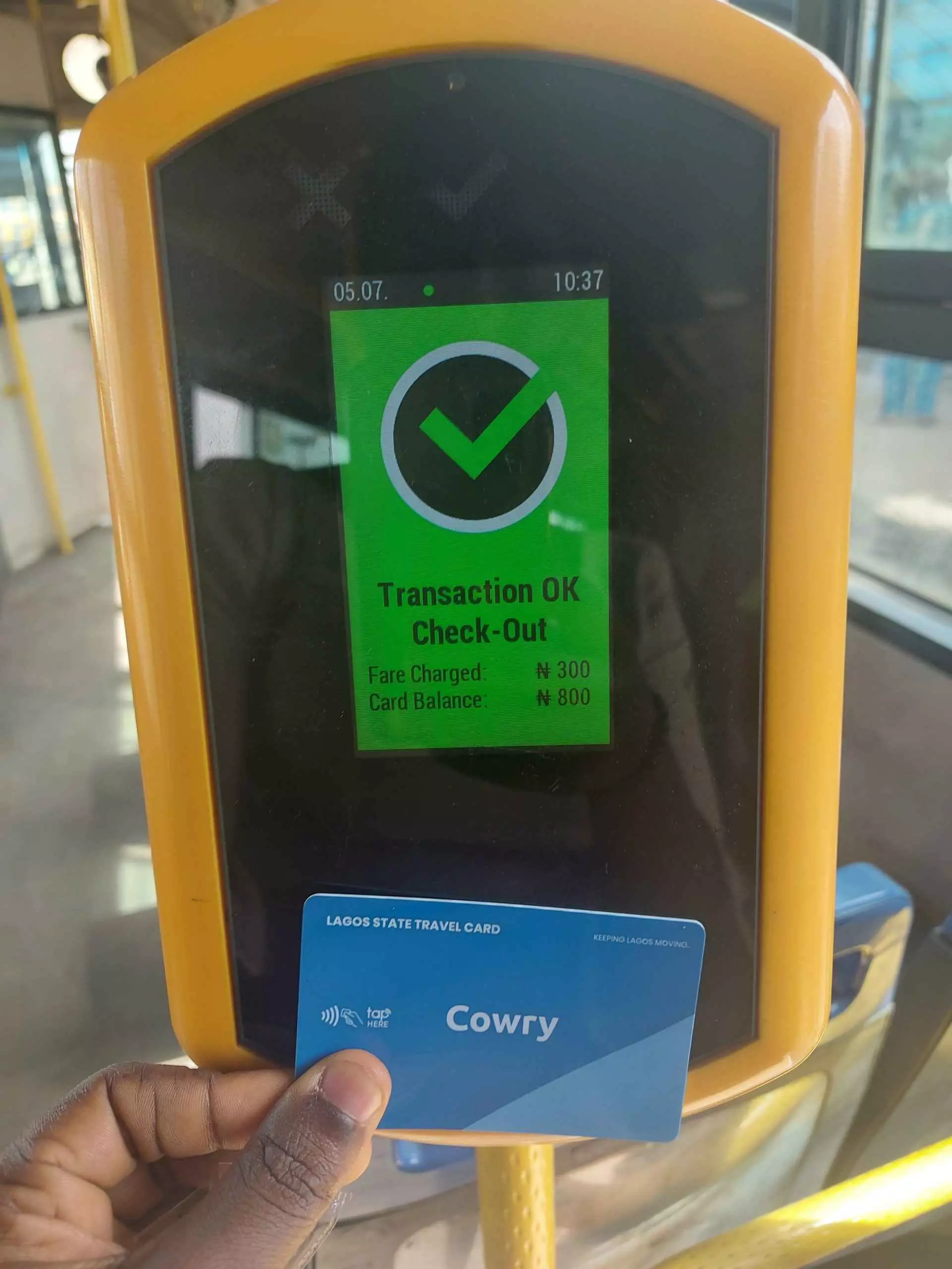 In a BRT bus, the cowry card validator displays a successful payment.