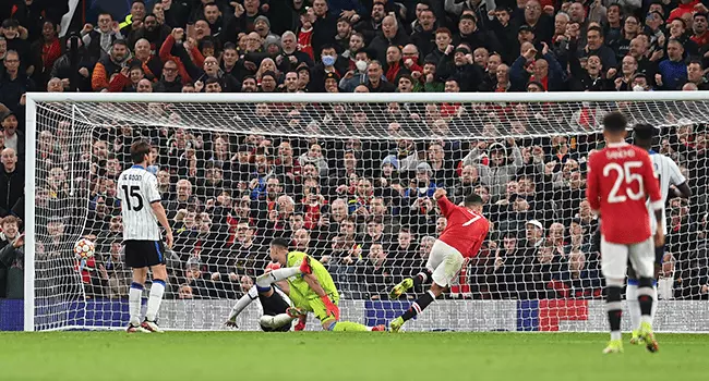 Manchester United's Portuguese striker Cristiano Ronaldo (3R) scores his team's third goal during the UEFA Champions league group F football match between Manchester United and Atalanta at Old Trafford stadium in Manchester, north west England, on October 20, 2021. Paul ELLIS / AFP