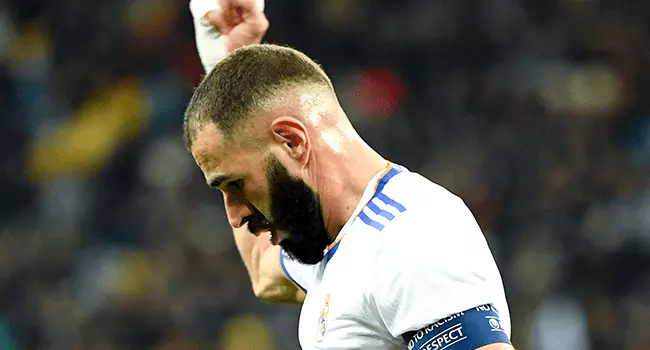 Real Madrid's French forward Karim Benzema celebrates after Shakhtar Donetsk's Ukrainian defender Serhiy Kryvtsov scored an own goal during the UEFA Champions League football match between Shakhtar Donetsk and Real Madrid at the Olympic Stadium in Kiev on October 19, 2021. Sergei SUPINSKY / AFP