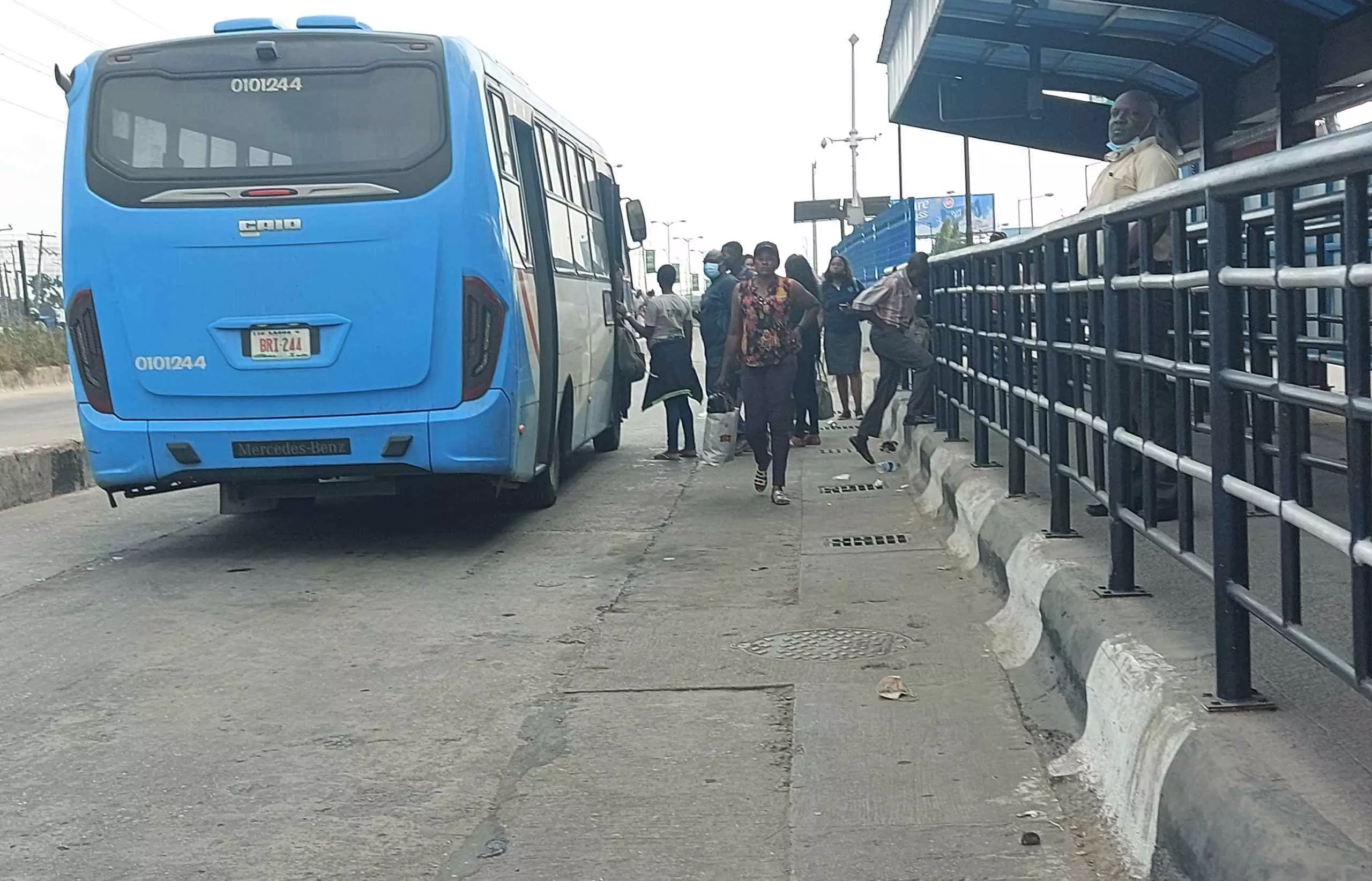 At Ketu station, a BRT bus is loading passengers